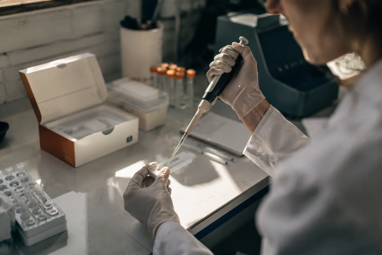 Laboratory work with a pipette and a sample slide.